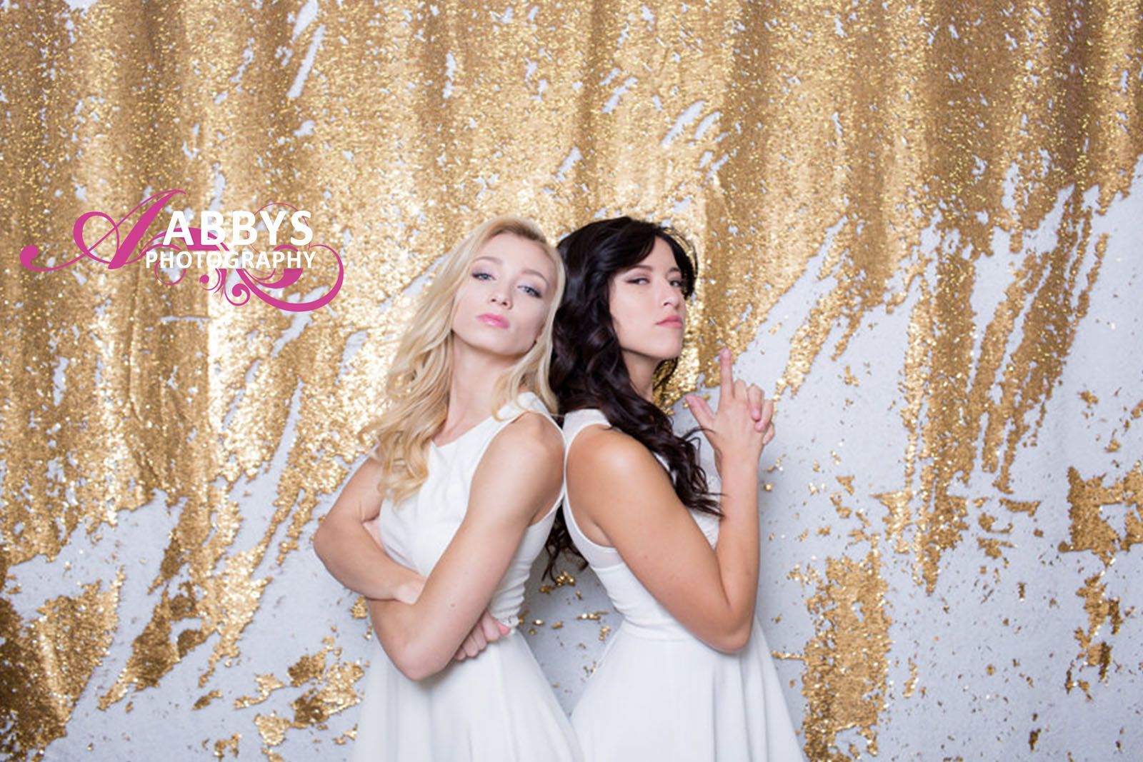 A photo booth best captures two friends posing at a Bakersfield event. 