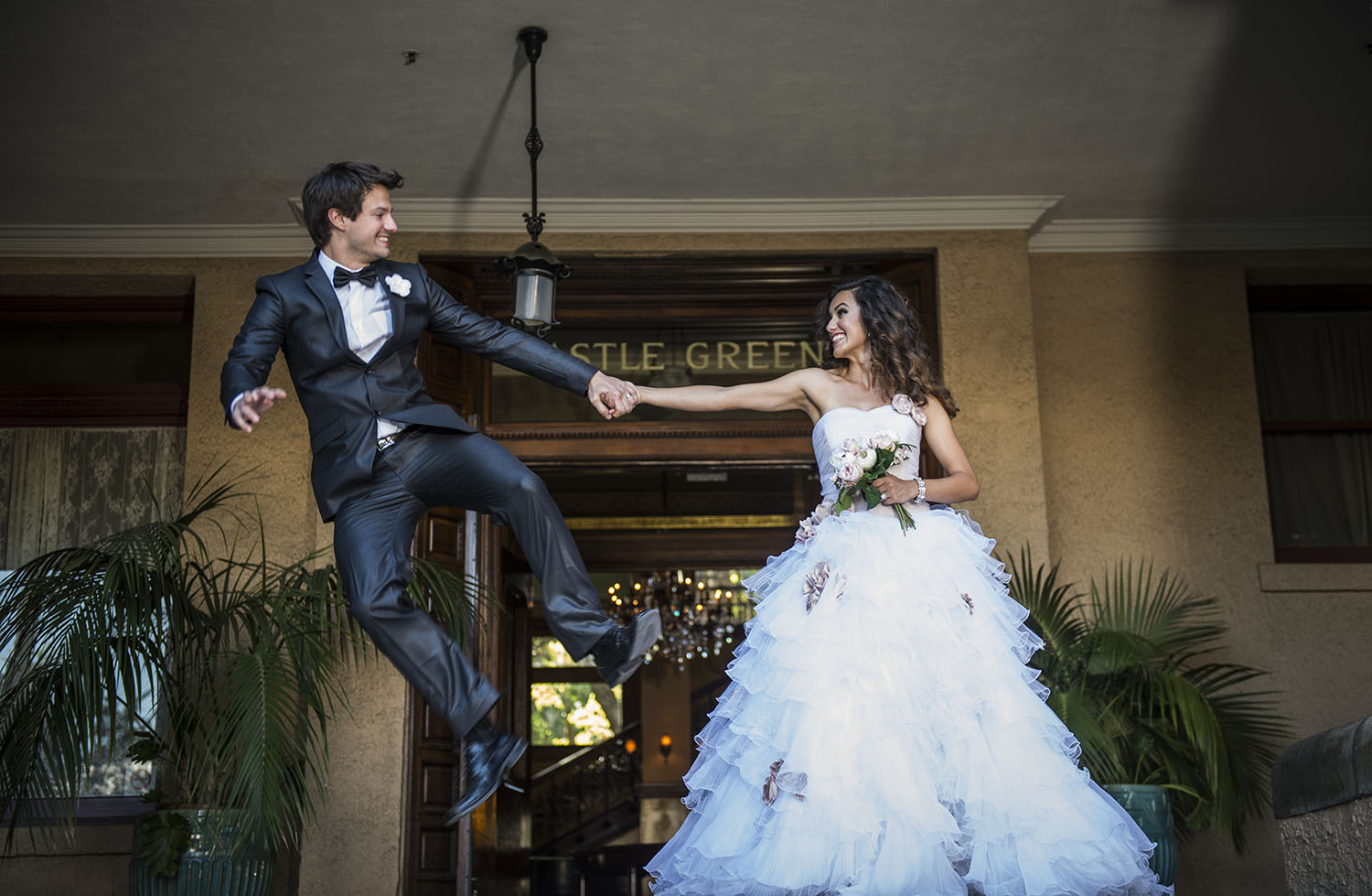 The groom jumps for joy because the wedding photography is so great. 